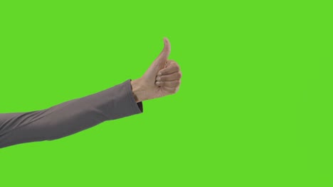 studio close up shot of woman giving thumbs up sign against green screen 1