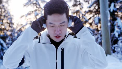 man doing stretching exercise while listening music on headphones 4k