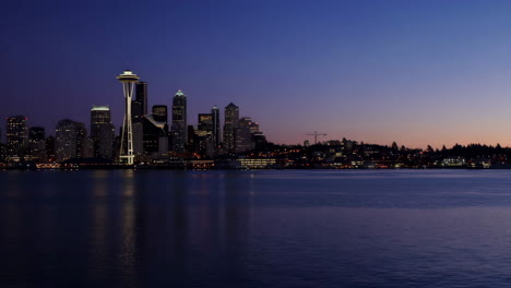 seattle skyline at dusk with space needle and water reflection