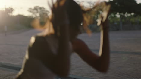 dancing-woman-young-hispanic-hip-hop-dancer-in-city-enjoying-fresh-urban-freestyle-dance-moves-practicing-expression-at-sunset-close-up