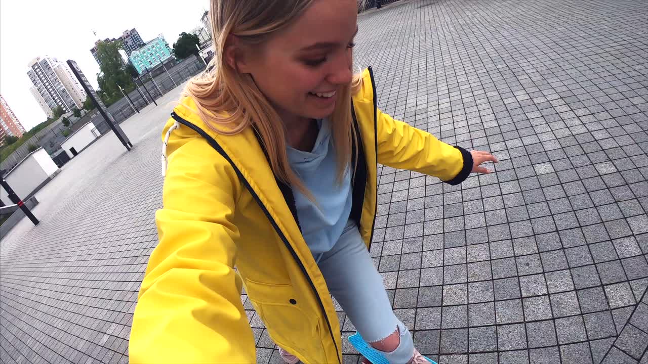 una mujer joven tomando una selfie en una patineta.
