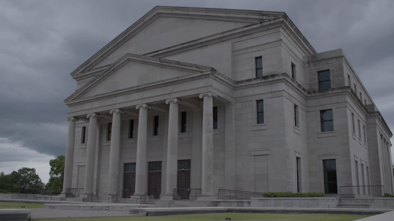 Medium pan: Stormy skies over the Mississippi State Supreme Court Building. Jackson, MS