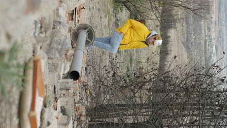 vertical shot of a devastated man walking alone in the forest after wildfire