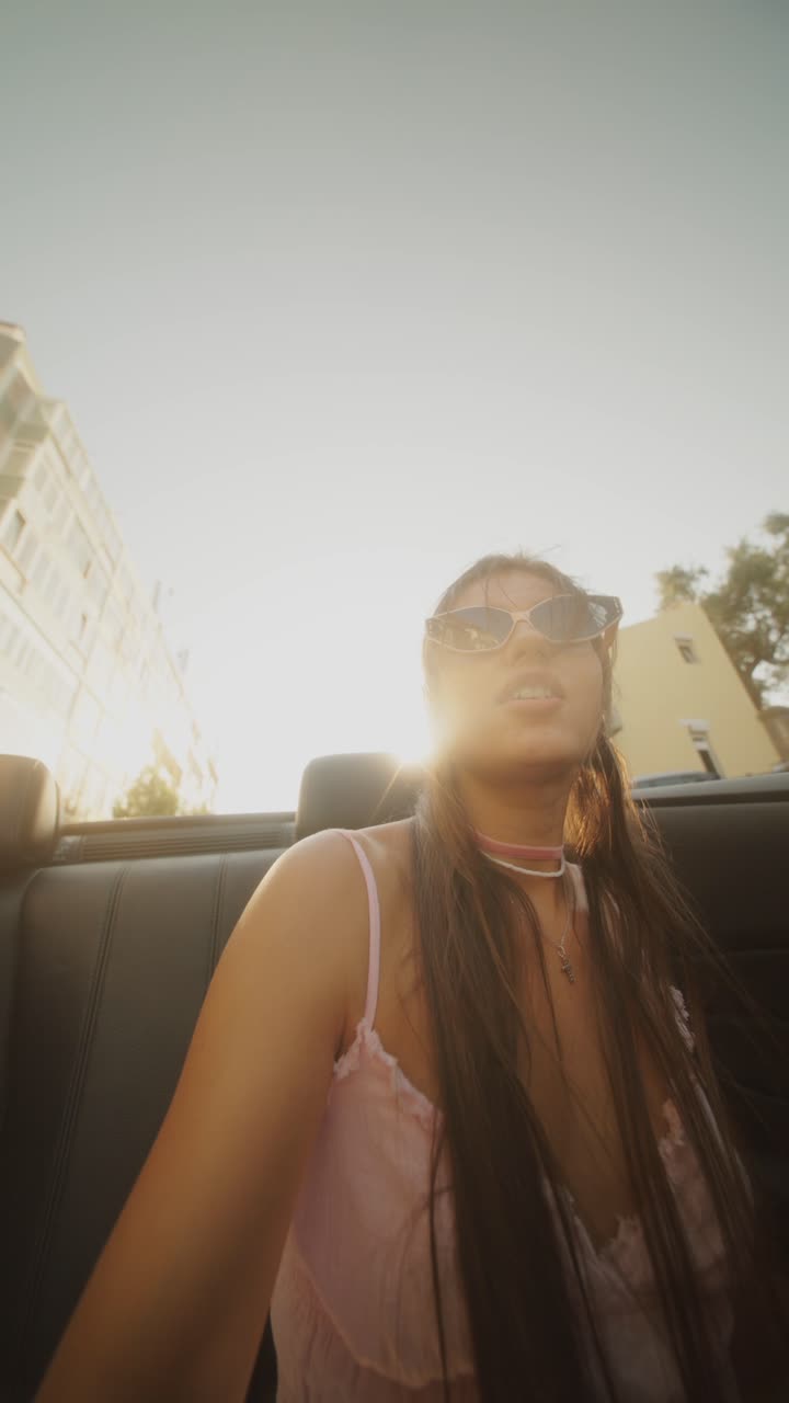 Woman in a convertible on a sunny day