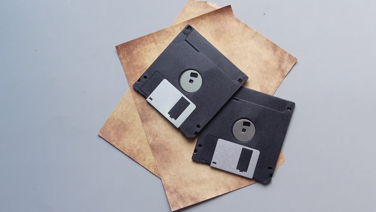 An old vintage floppy disk on a gray background