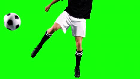 athlete practicing soccer against green screen
