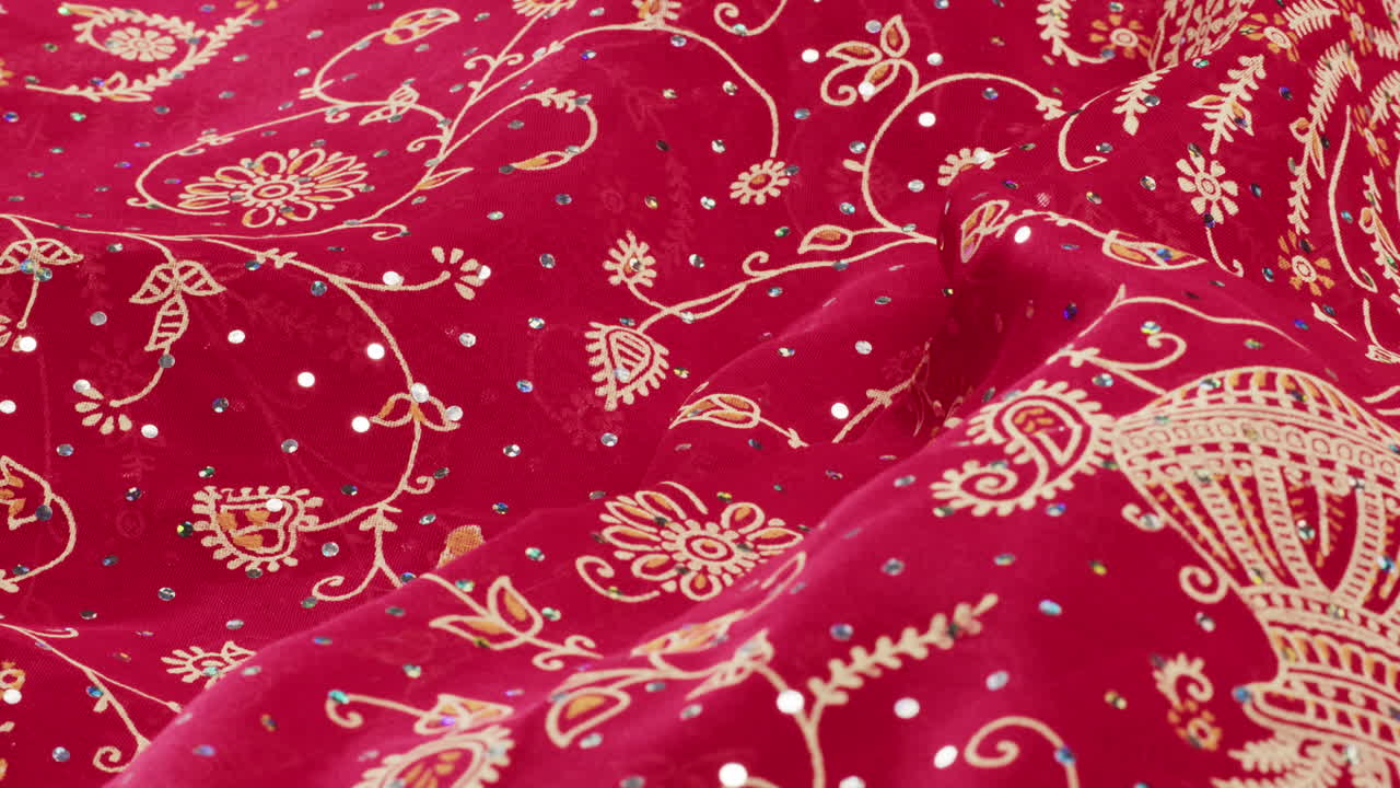 Close-up of Red Fabric with Floral Pattern and Sequins
