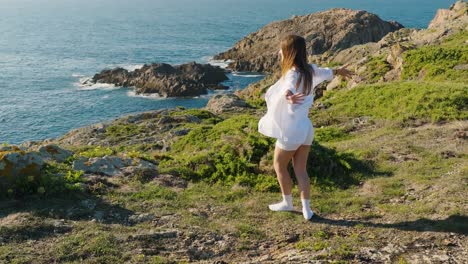 Female-Wanderlust-On-Galician-Coast-Turning-Around-With-Arms-Wide-Open-During-Summer-In-Ferrol,-Spain