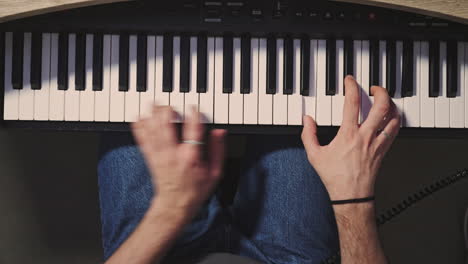 Close-up-of-pianist's-hands-professionally-play-the-piano-top-down-of-caucasian-skilled-musician