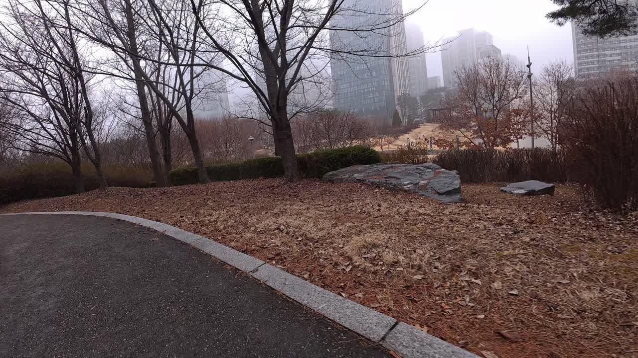 Walking Over The Footpath During A Misty Morning In Songdo Central Park In Incheon, South Korea. POV Shot