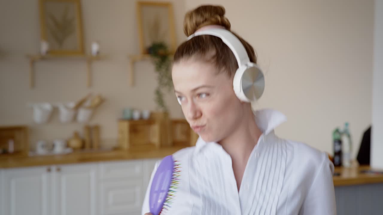 Young Woman Singing and Dancing in Kitchen