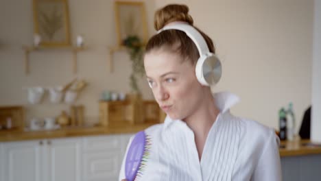 Young Woman Singing and Dancing in Kitchen