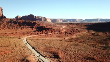 Aerial-Shot-Of-Tourist-Cars-Driving-Through-Monument-Valley,-Tourist-Destination-In-USA