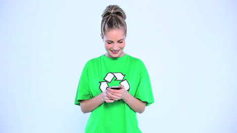 attractive woman wearing a green tshirt with recycling symbol on it