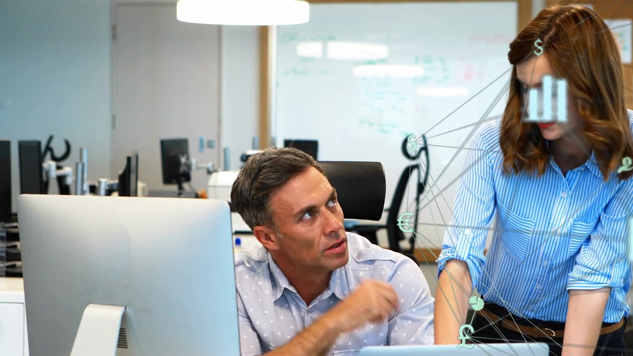 Vertical video: Woman pointing at laptop, guiding man to monitor for business, charts tracking