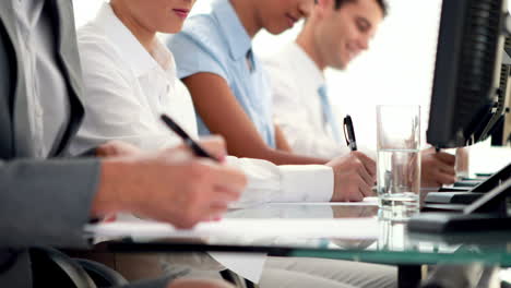 business people writing on paper in call center