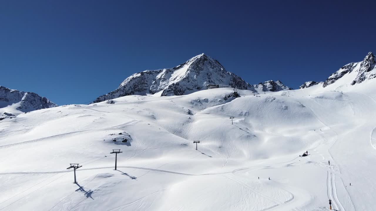 Ski slopes of Stubai, view from air. Aerial drone shot of mountains covered  with snow. Ski resort in Austrian Alps.