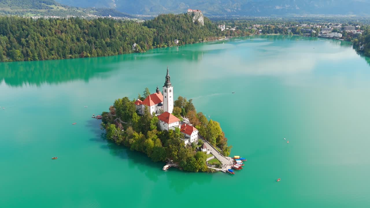 Picturesque lake Bled island surrounded by turquoises waters. Aerial