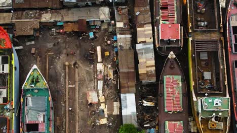 a dockyard with several boats being refurbished in asia