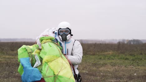 person preparing paragliding equipment