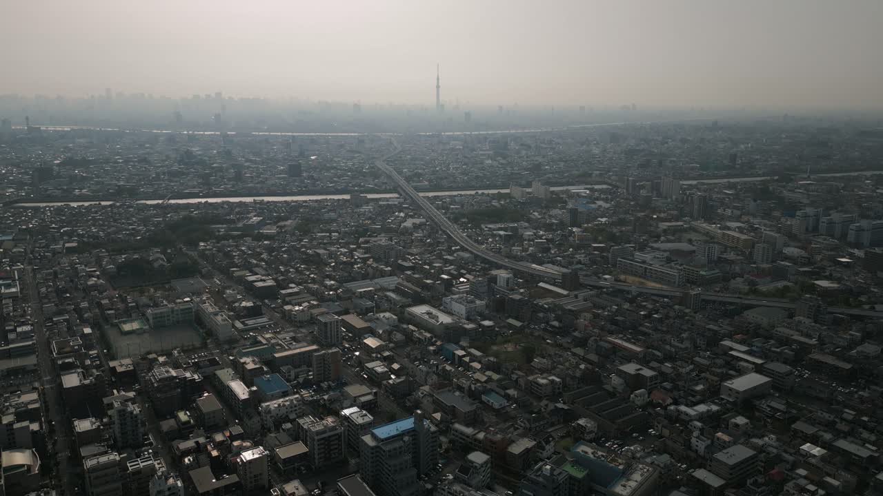 Aerial Scenic Urban Drone Footage of a neighborhood, streets and buildings in the Capital City of Tokyo, Japan during Sunset