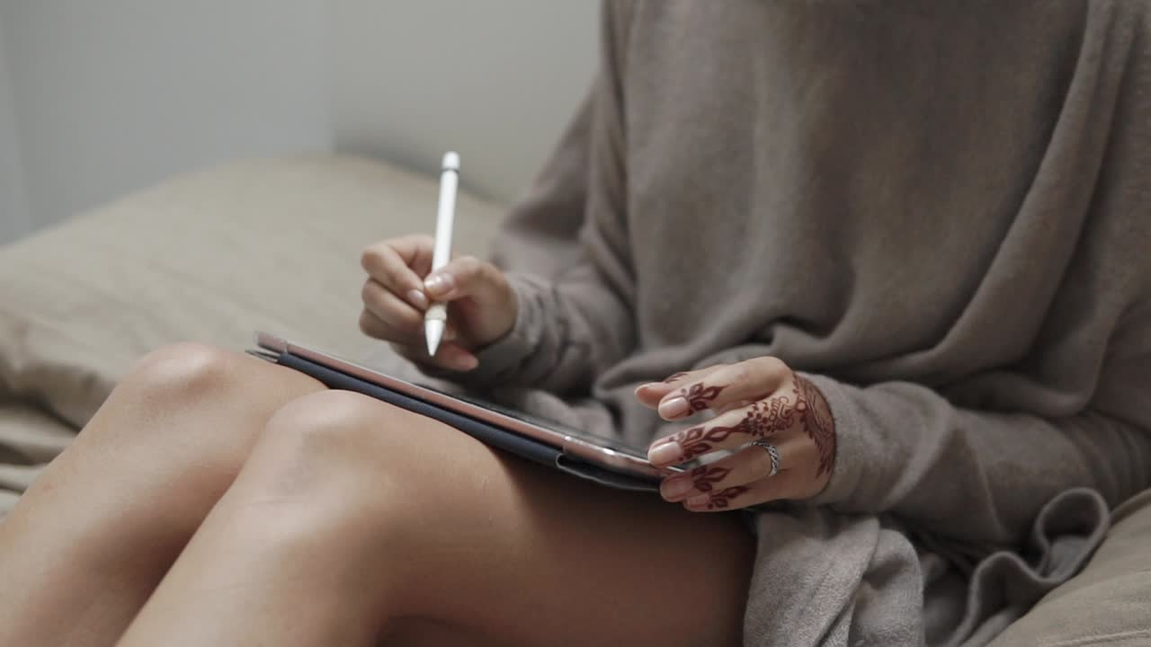 Woman using tablet and stylus for digital art