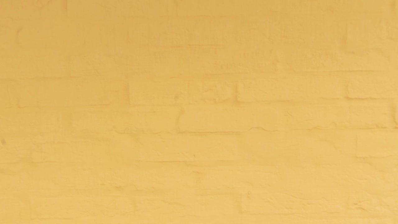 Textured yellow brick wall background