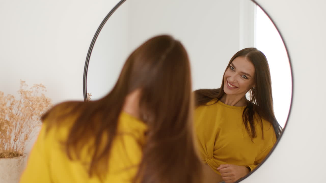 Woman smiling in front of mirror