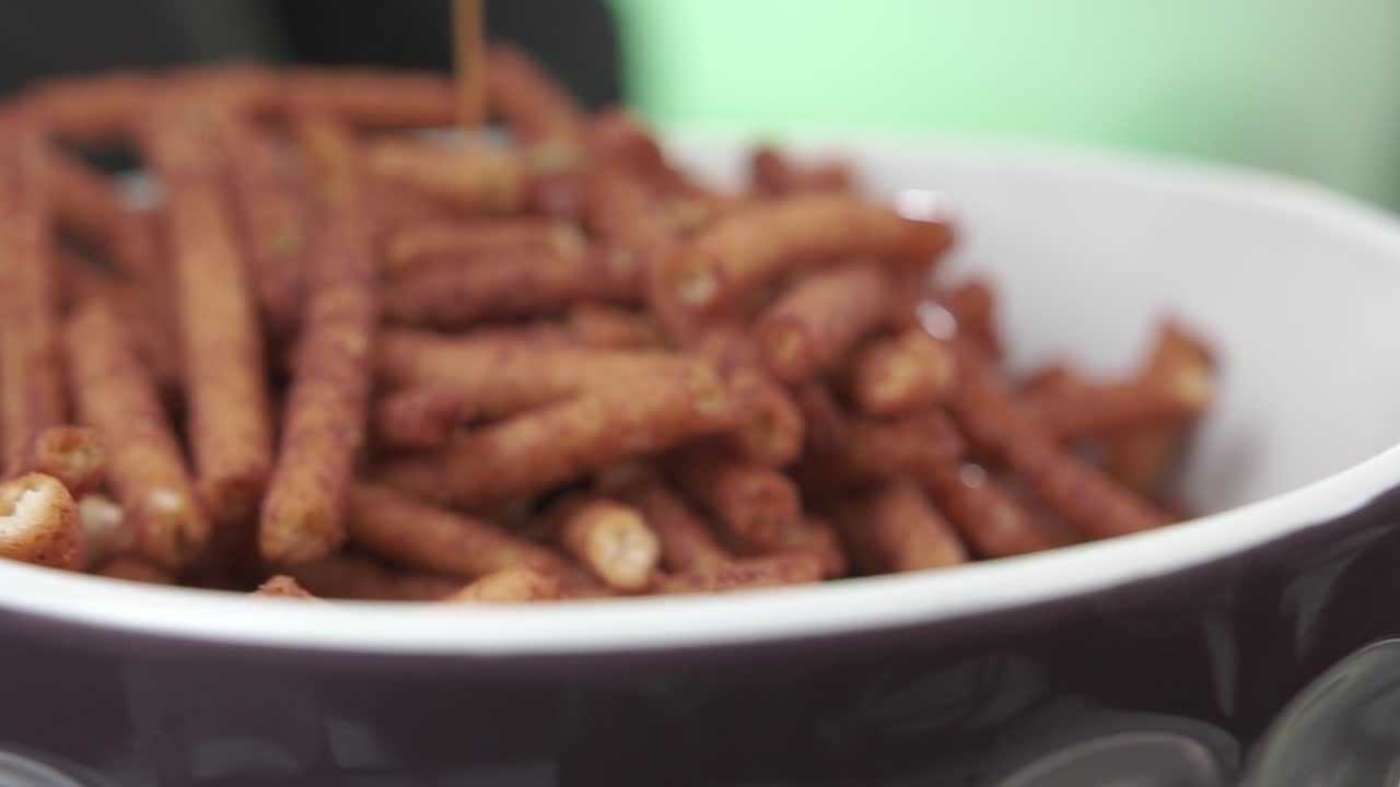 Primo piano di pretzel in una ciotola con cioccolato versato sopra