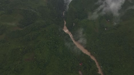Aerial-view-of-brown-cahabon-river-at-Guatemala-during-rain-season,-drone