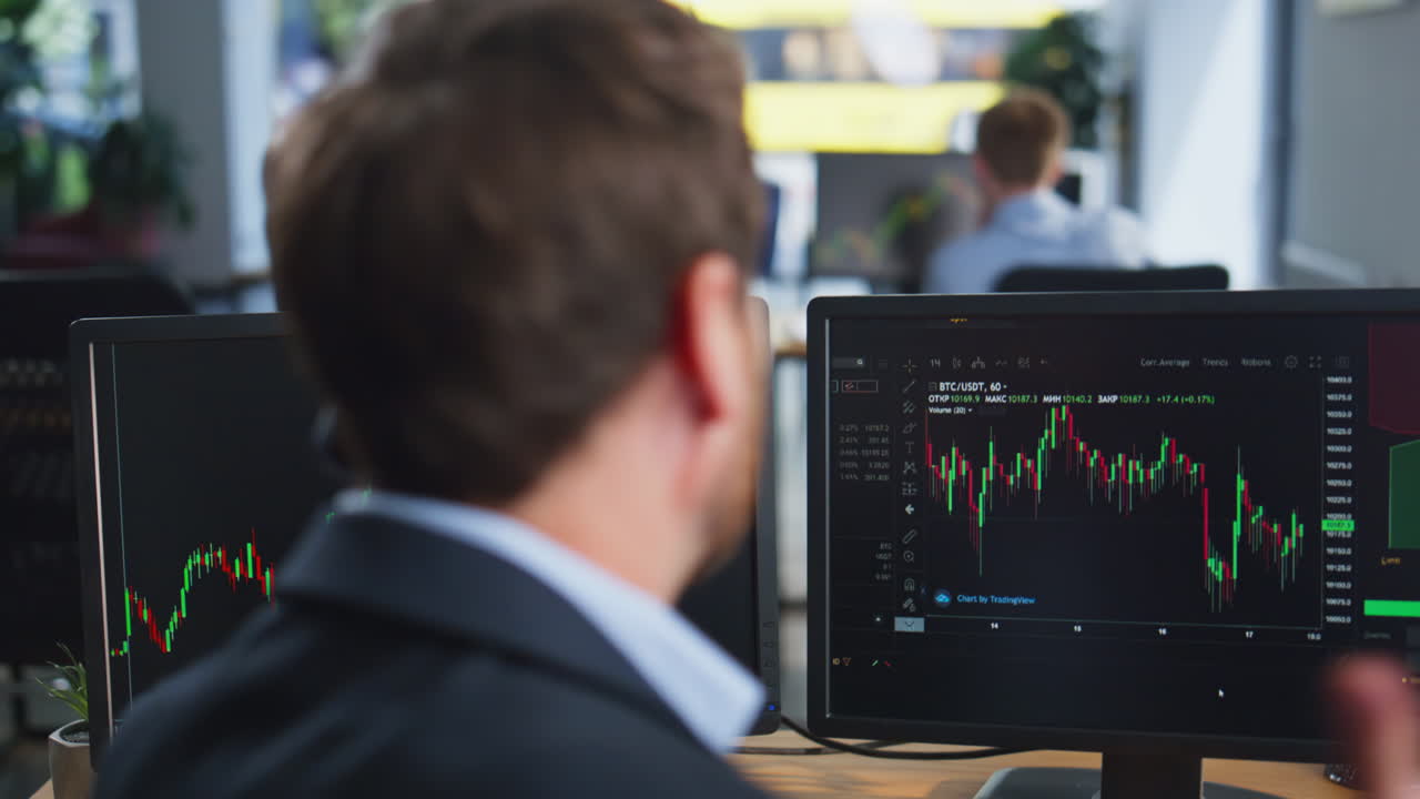 Nervous investor talking mobile phone discussing stock market in office closeup