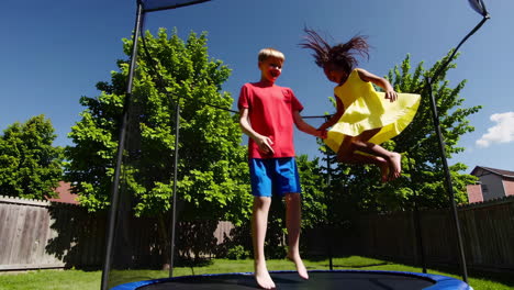 kids jumping on a trampoline in the backyard