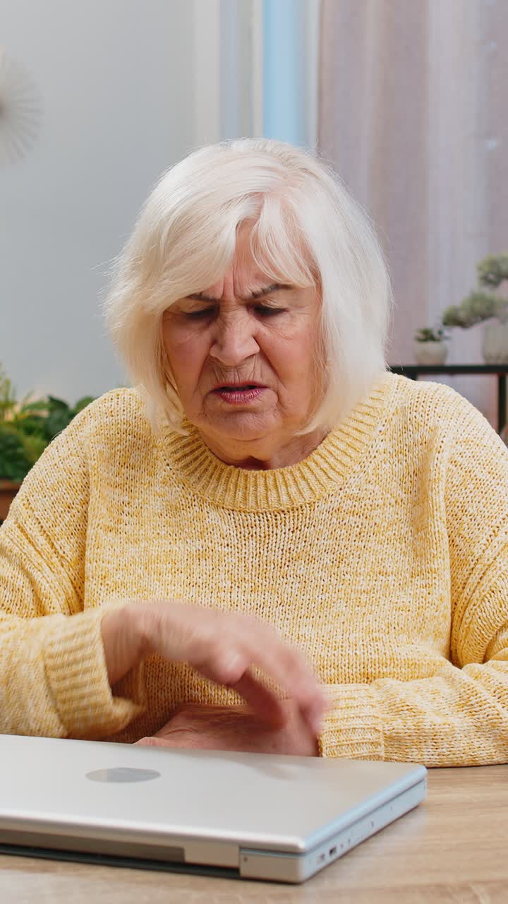 Unhappy sad senior elderly woman use laptop bad news fortune loss game fail lottery results at home