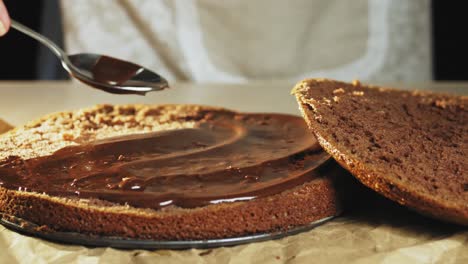 woman spreading a cream on the baked dough