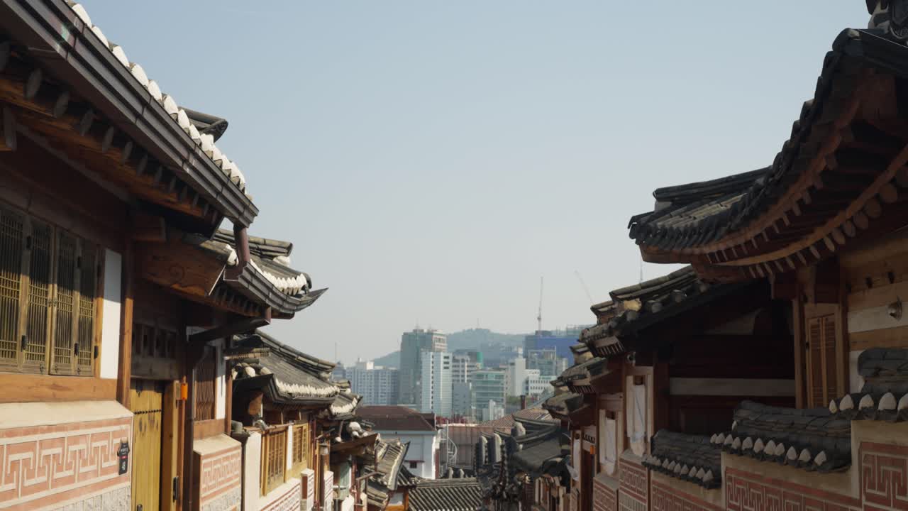 Traditional street in Bukchon Hanok Village, Seoul, reveals authentic Hanok houses and a distant cityscape with the iconic N Seoul Tower, Truck Right