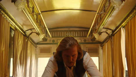 man dancing in a vintage train carriage