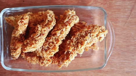 crispy fried chicken fingers in a glass dish