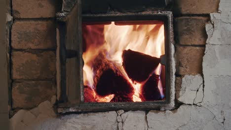 fireplace - old russian oven with burning wood, fire in open door