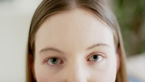 Portrait-of-happy-caucasian-woman-looking-at-camera-at-home,-in-slow-motion