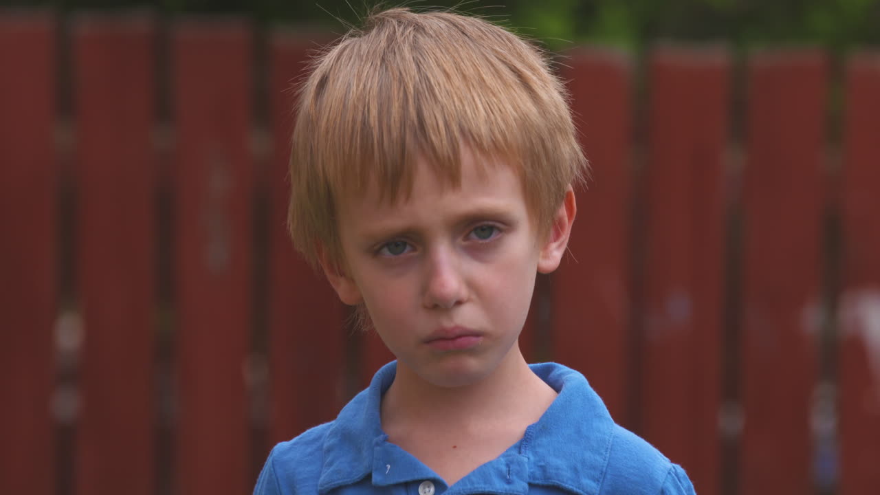 Premium stock video - Portrait of a sad little boy turning toward the ...