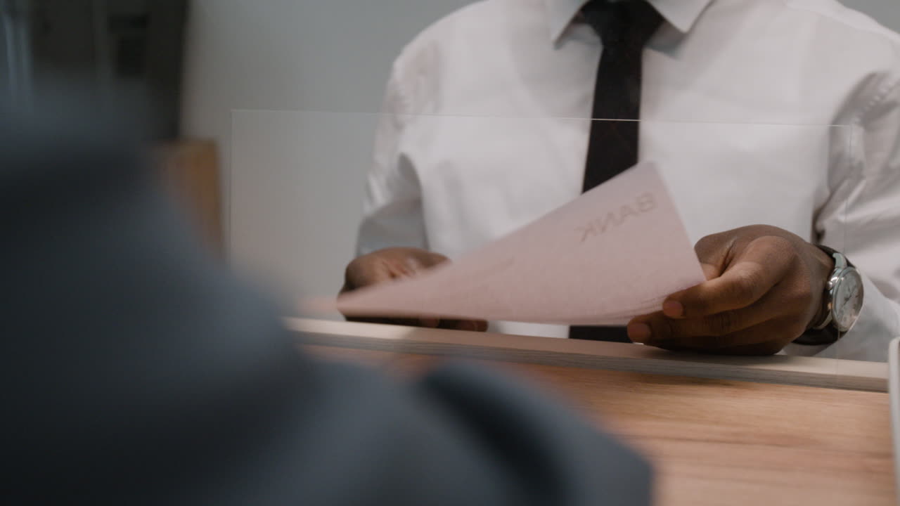 Person signing a document at a bank