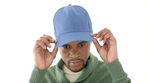 african american man wearing blue peaked cap with copy space on white background