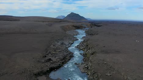 flying a drone along a river with pure and fresh cold water in the highlands of iceland. copy space.