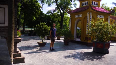 tourist wandering around the tran quoc pagoda temple