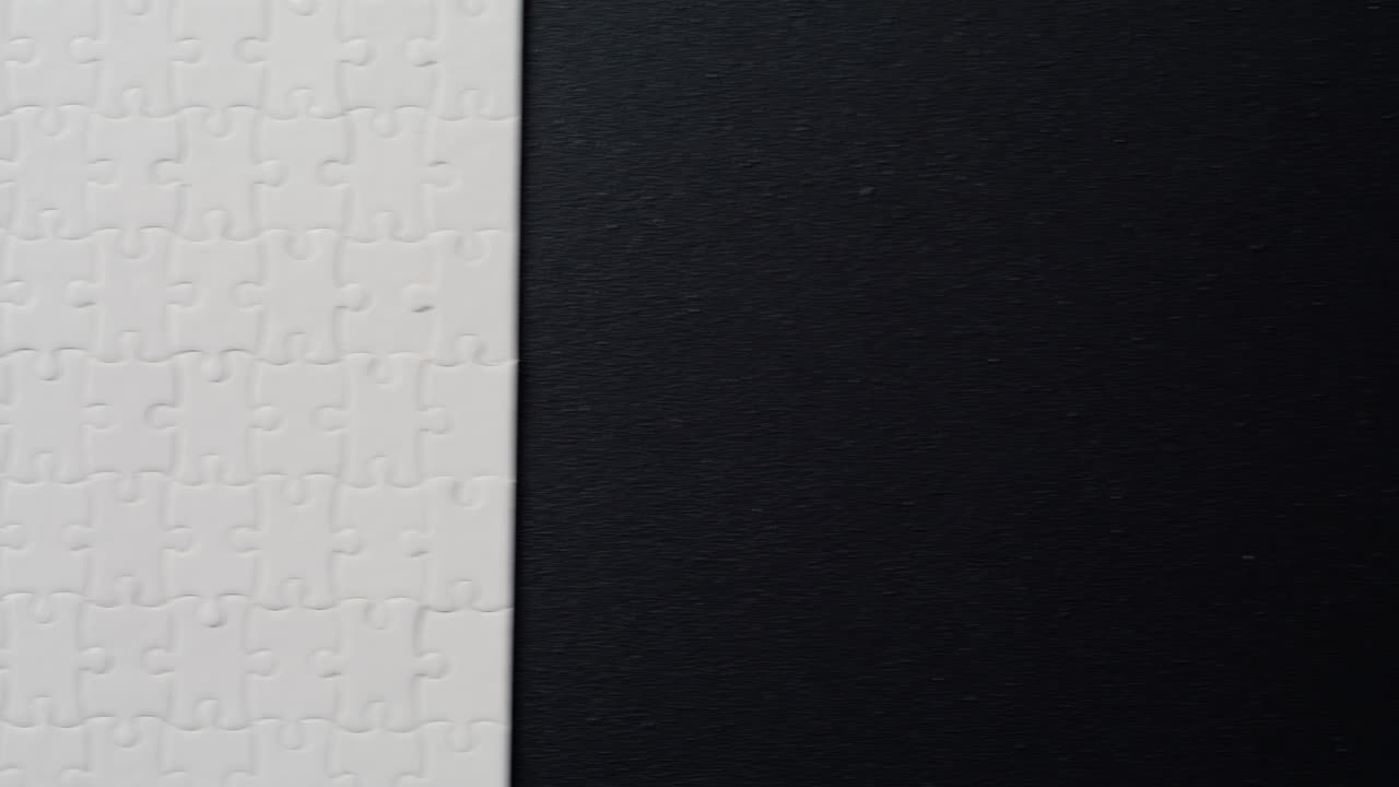 Light puzzle segments assembled on dark surface showing missing pieces closeup