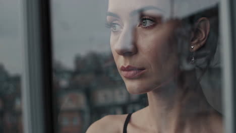pensive woman gazing out a window