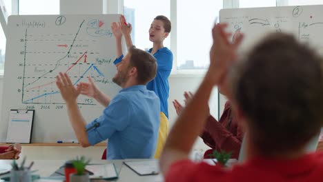 happy business people celebrating success in meeting room