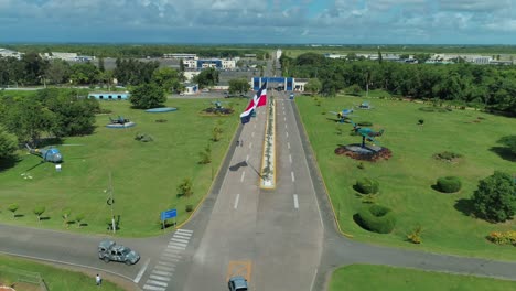 entrance of the military air base of san isidro, dominican republic, flag waving on a clear day, shot with drone