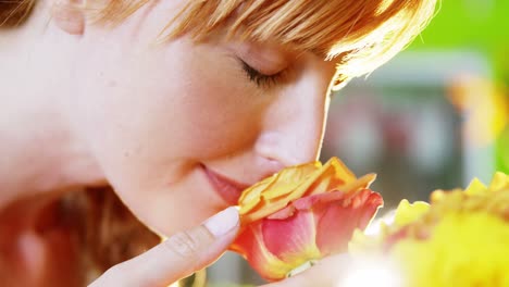 beautiful female florist smelling rose