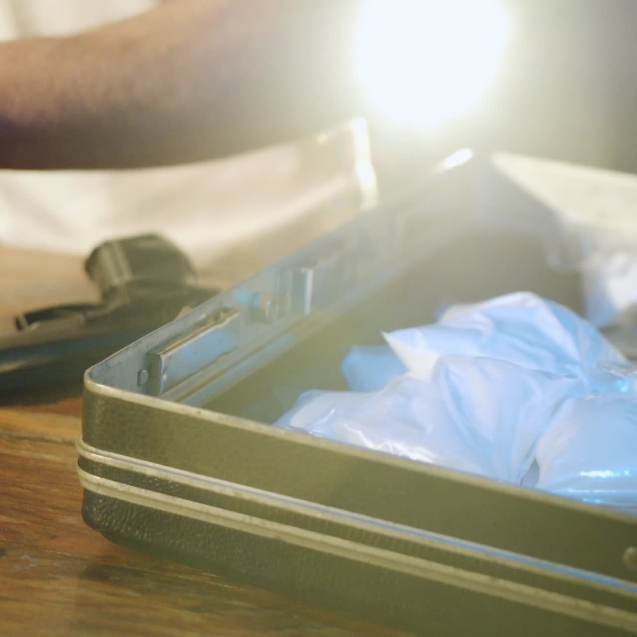 Close-up. Drug dealer is packing drugs into suitcase. Abuse of drugs. Criminal Business